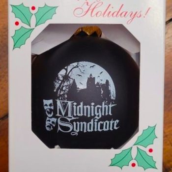 Midnight Syndicate black glass ornament with logo in box.